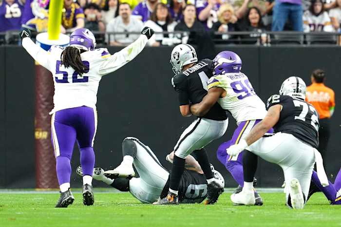 Dec 10, 2023; Paradise, Nevada, USA; Minnesota Vikings defensive tackle Sheldon Day (52) celebrates as Minnesota Vikings linebacker D.J. Wonnum (98) sacks Las Vegas Raiders quarterback Aidan O'Connell (4) during the second quarter at Allegiant Stadium.